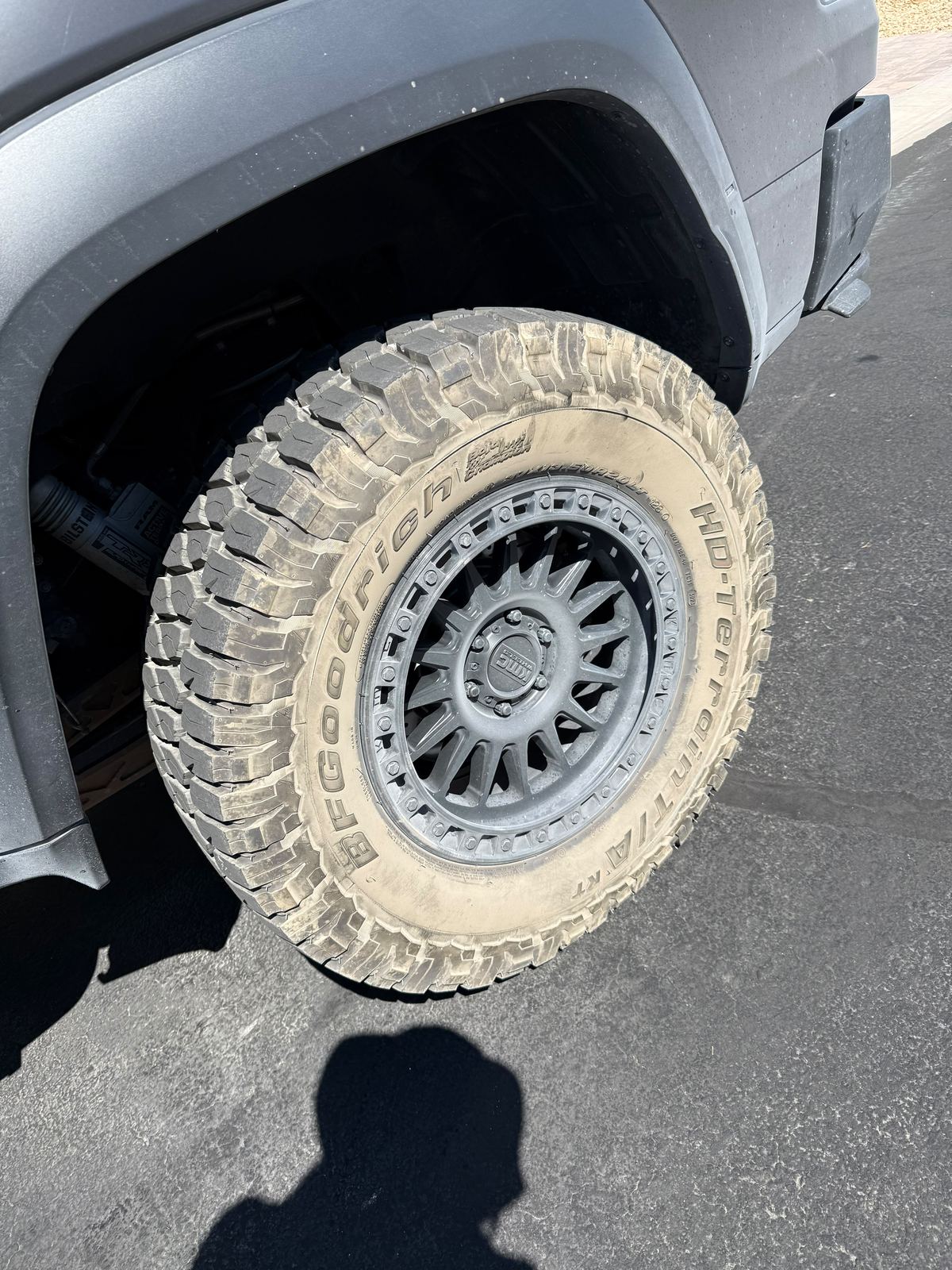 Close-up of a GMC Sierra off-road wheel and mud tire after degreasing