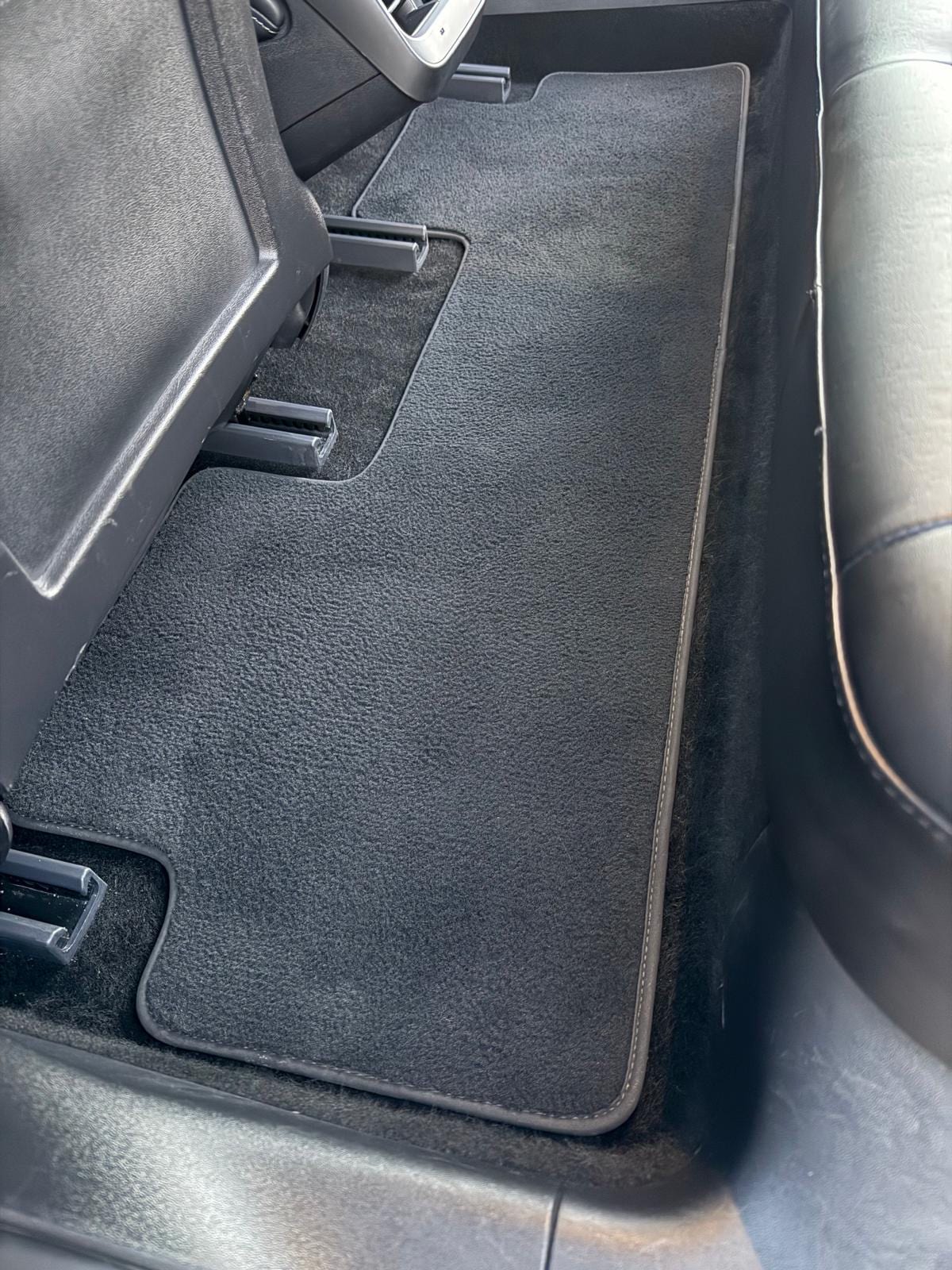 Filthy rear floor carpet and mats deep-cleaned back to factory condition — after detailing