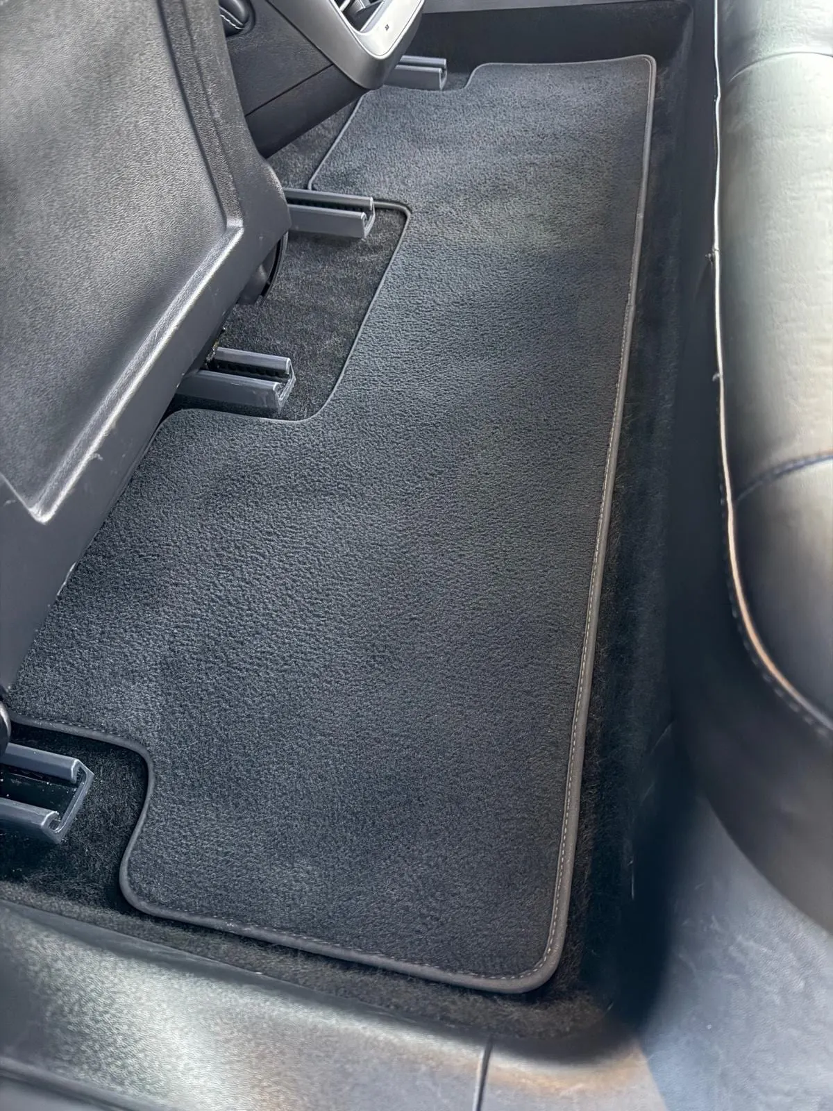 Filthy rear floor carpet and mats deep-cleaned back to factory condition — after detailing